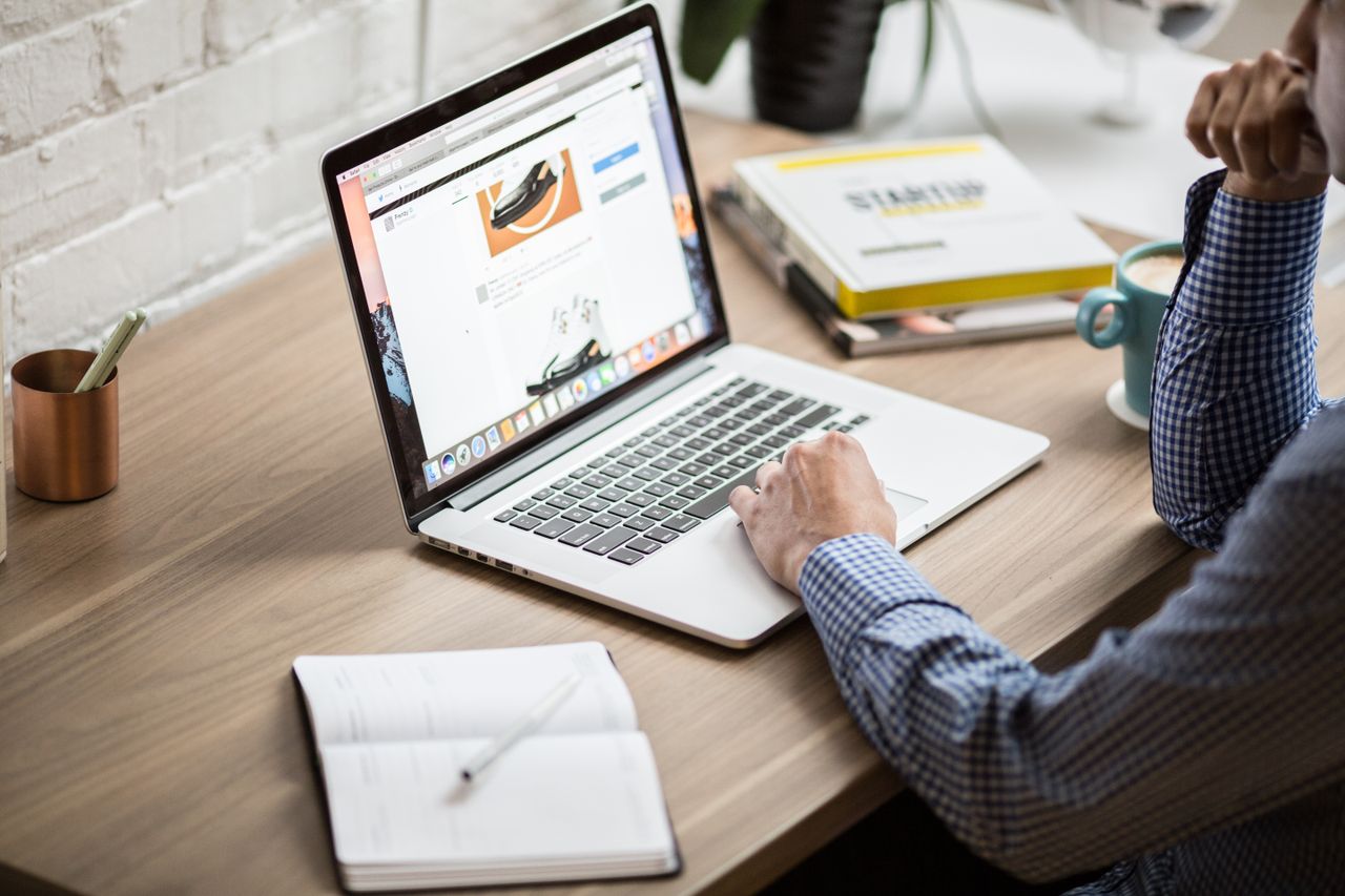 Mastering the First Impression: Your intriguing post title goes here Adult working on a laptop in a modern office setting, illustrating productivity and concentration.